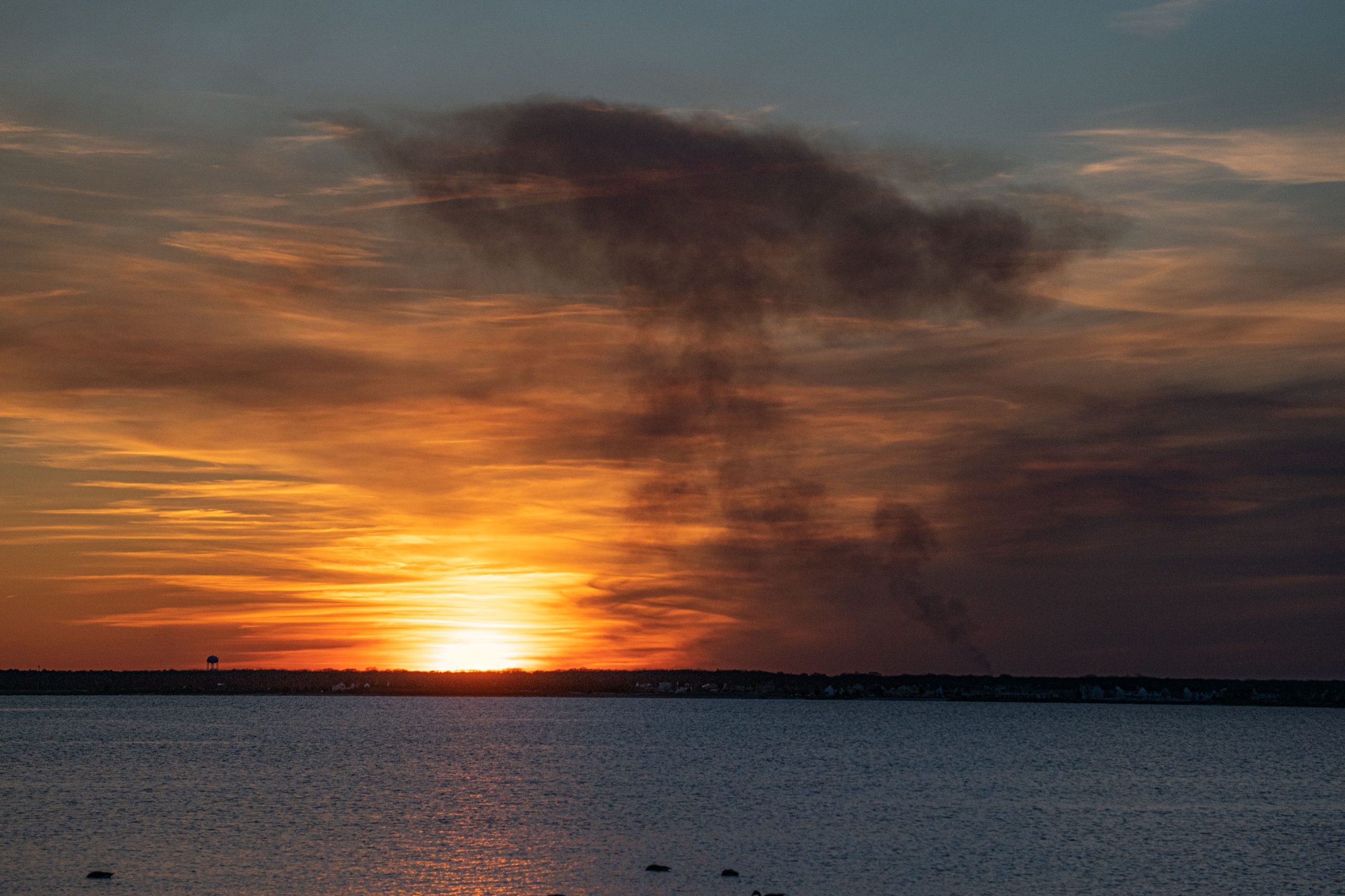 A controlled burn in Ocean County, N.J. produces a plume of smoke over Barnegat Bay, Feb. 28, 2022. (Photo: Daniel Nee)