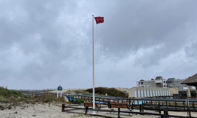 A red flag flies over cloudy skies at Brick Beach III, May 6, 2022. (Photo: Daniel Nee)