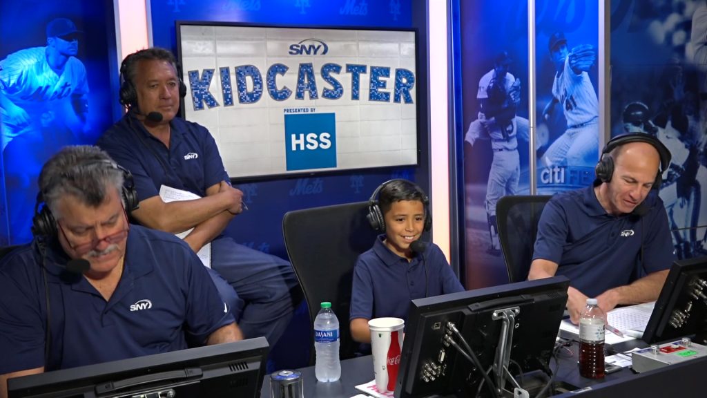 A Toms River 'Kid-Caster' calls an inning with the New York Mets' broadcast team, Aug. 8, 2023. (Credit: SNY)